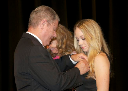 USCB officially graduated 28 new nurses during a brief ceremony Saturday afternoon at the USCB Performing Arts Center. Here, Mike Ryan pins his daughter Katherine Christine Ryan.  Photo by Bob Sofaly
