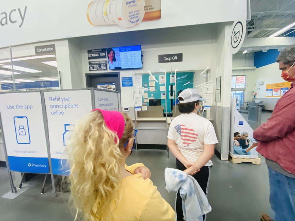 Hogan and Ceci Wareham, Ages 8 and 11 , waiting to receive their first Covid-19 shots at Walmart on Lady's Island